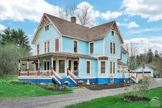 view of front of house featuring a porch, an outdoor structure, a shingled roof, and a chimney