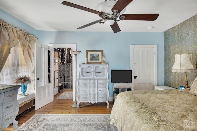 bedroom featuring a ceiling fan and wood finished floors