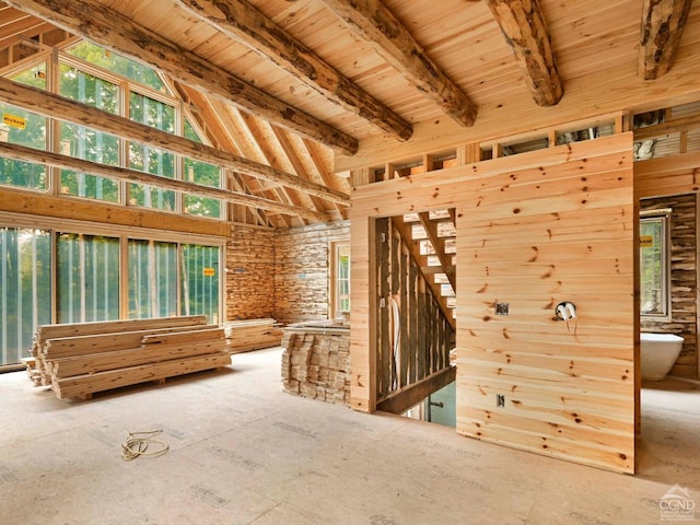 misc room featuring beam ceiling and high vaulted ceiling