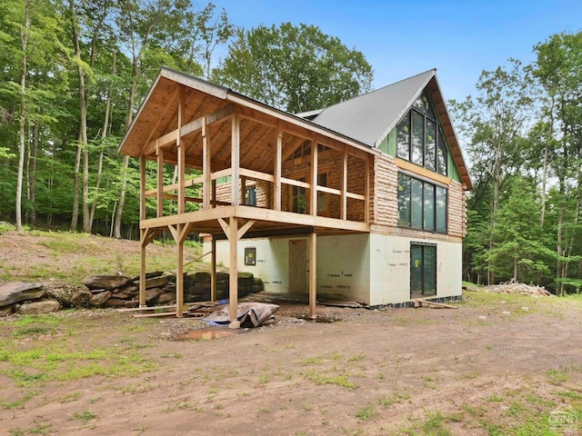 rear view of house featuring a wooden deck