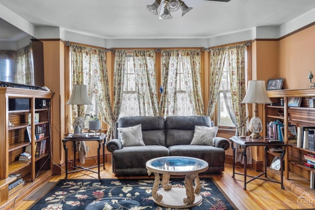 sitting room featuring ceiling fan and wood-type flooring