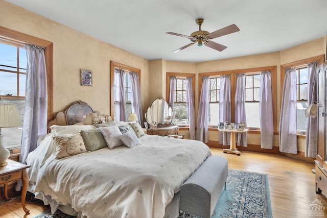 bedroom featuring light hardwood / wood-style floors and ceiling fan