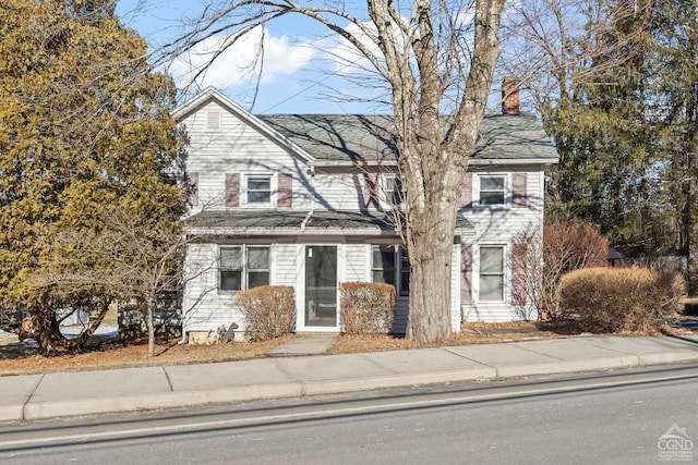 view of front facade featuring a chimney