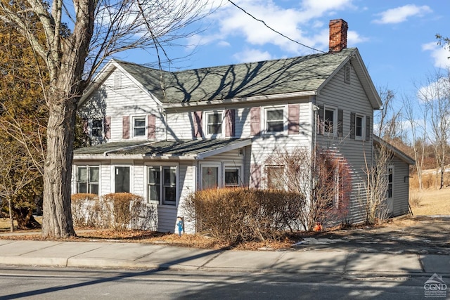 view of front of home featuring a chimney