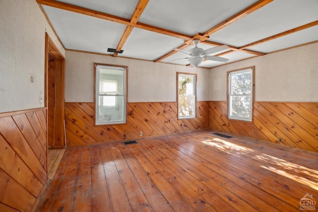 unfurnished room with coffered ceiling, wainscoting, visible vents, and hardwood / wood-style flooring