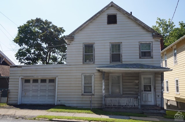 view of front of home with covered porch and a garage