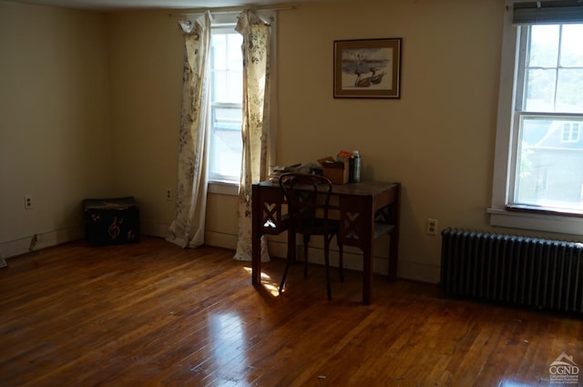 dining room with radiator heating unit and dark hardwood / wood-style flooring