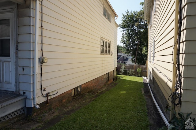 view of side of property with a yard