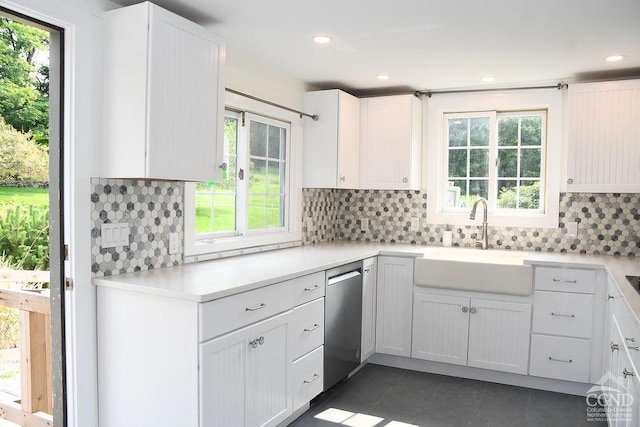 kitchen with plenty of natural light, white cabinetry, and sink