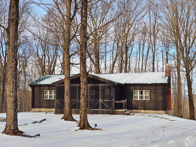 view of front of house featuring a sunroom