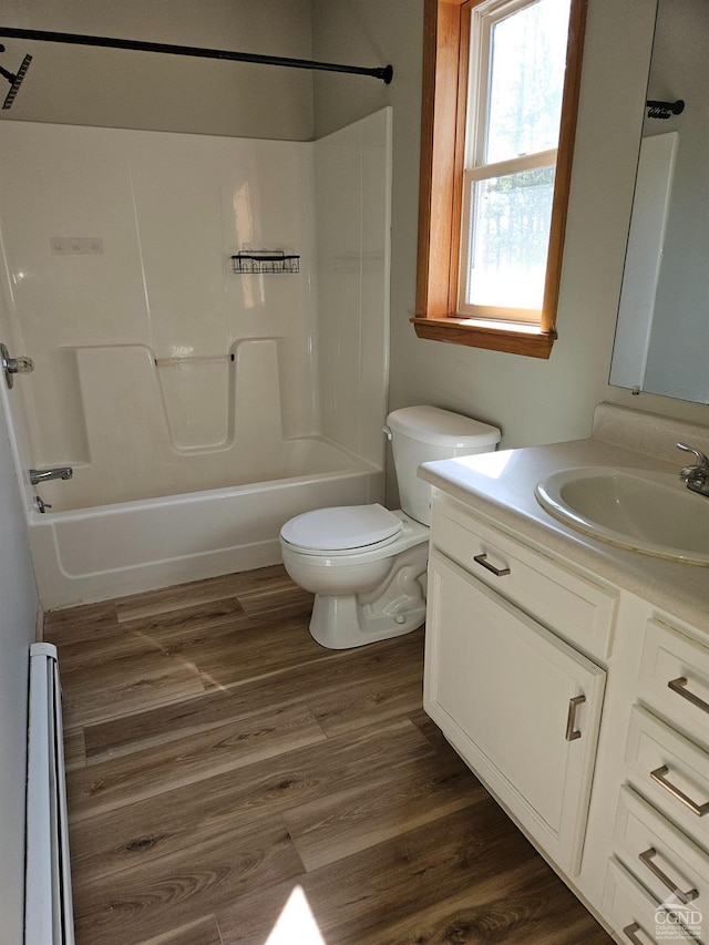 full bathroom with shower / bathtub combination, toilet, vanity, and wood finished floors