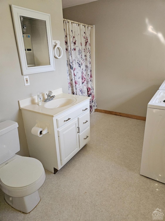 full bath with washer / dryer, toilet, and vanity