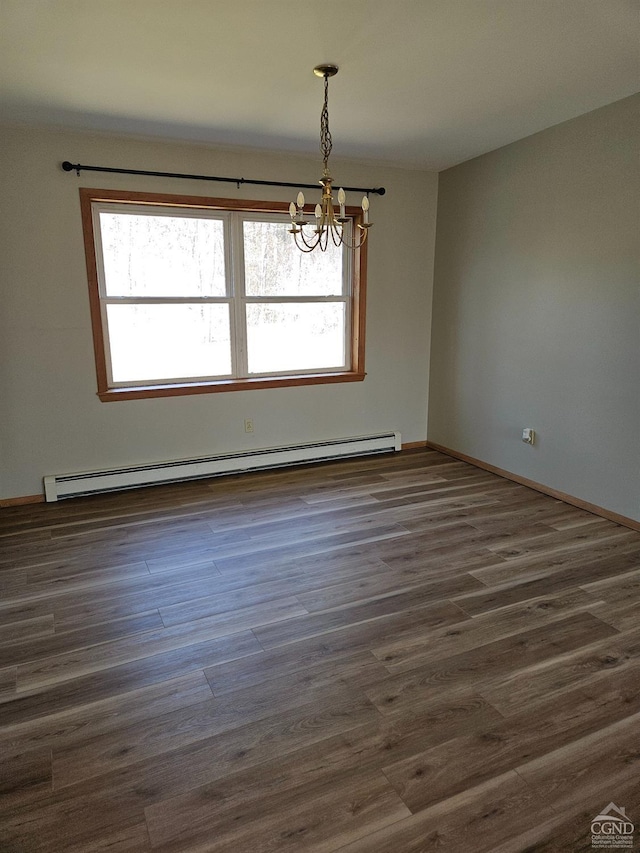 unfurnished room featuring a chandelier, a healthy amount of sunlight, baseboard heating, and dark wood-style floors