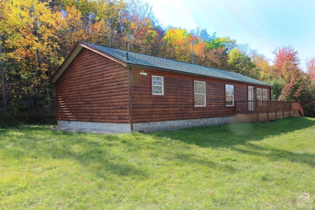 view of property exterior featuring a yard and a deck