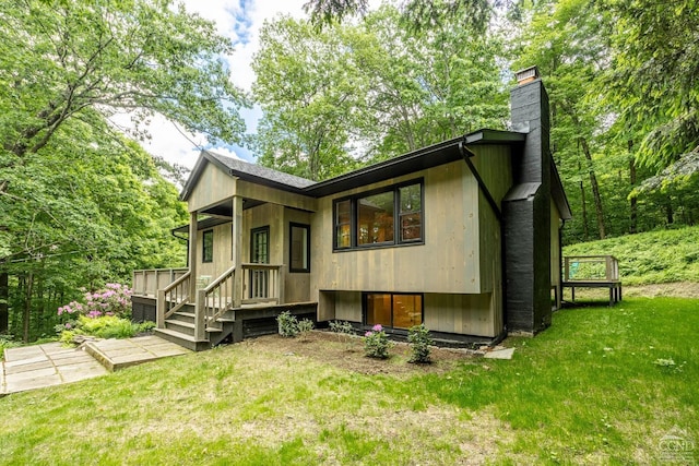 rear view of property with a yard