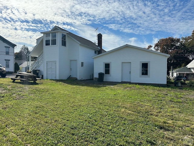 rear view of house featuring a lawn