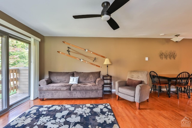 living room featuring ceiling fan and wood-type flooring