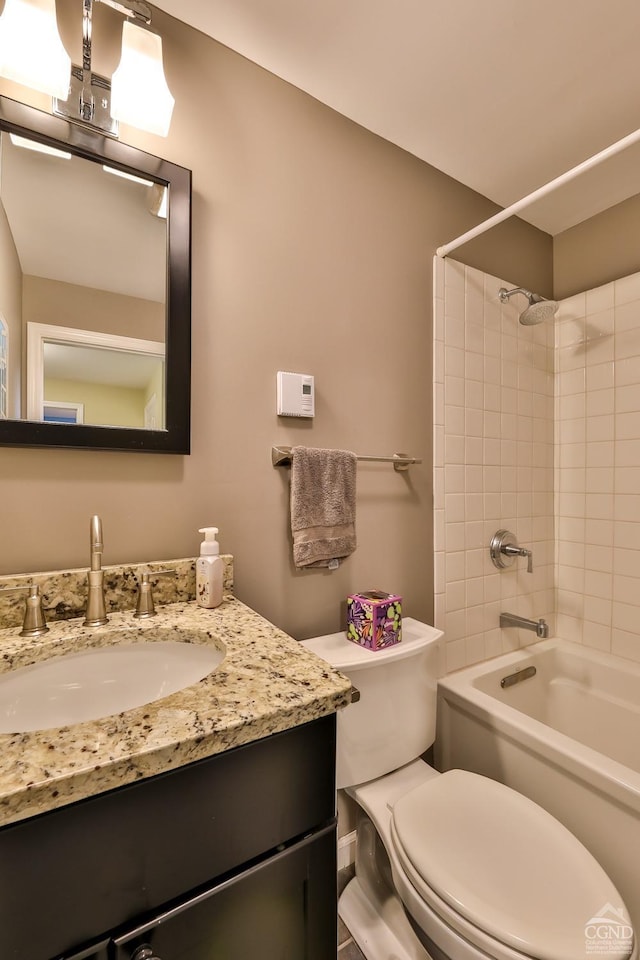 full bathroom featuring vanity, toilet, and tiled shower / bath