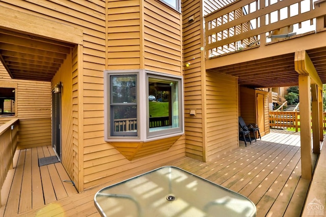 wooden deck featuring a hot tub