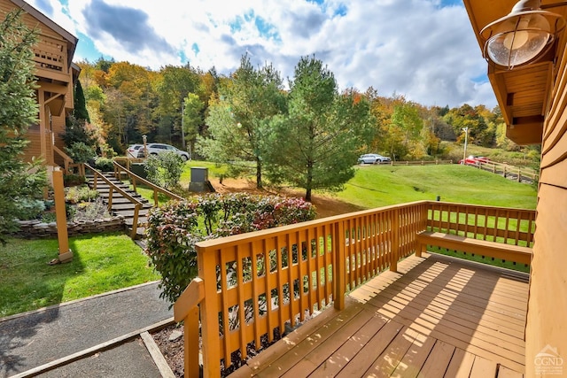 wooden terrace featuring a yard