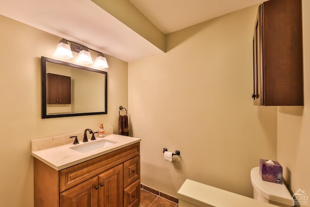 bathroom featuring tile patterned flooring, vanity, and toilet