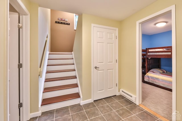 stairs with tile patterned flooring and a baseboard radiator