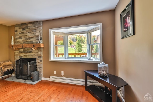 living room featuring a baseboard radiator and light wood-type flooring