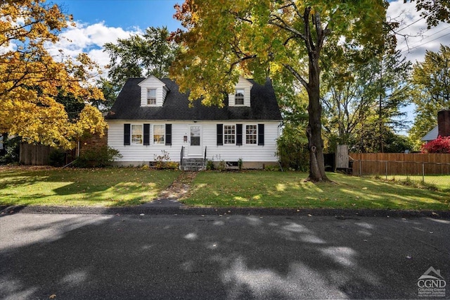 cape cod home with a front yard