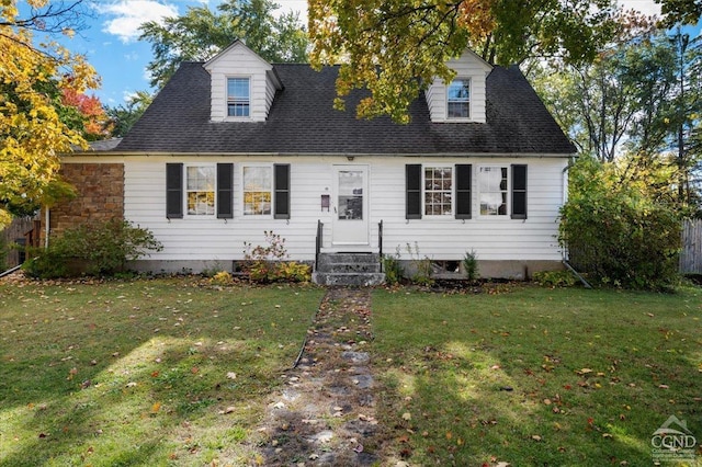 cape cod home with a front lawn