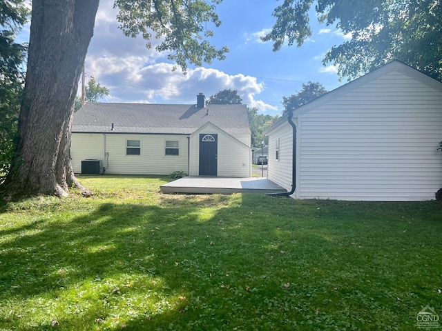 back of property with cooling unit, a yard, and a patio