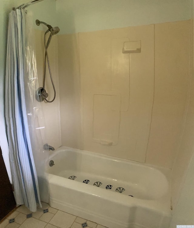 full bath featuring tile patterned flooring and shower / tub combo with curtain