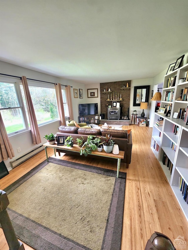 living area featuring light wood finished floors and a baseboard radiator