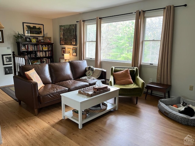 living room with a wealth of natural light and light wood-style flooring