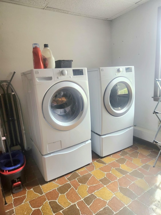 clothes washing area featuring independent washer and dryer and laundry area