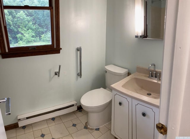 half bath with a baseboard radiator, baseboards, toilet, tile patterned floors, and vanity