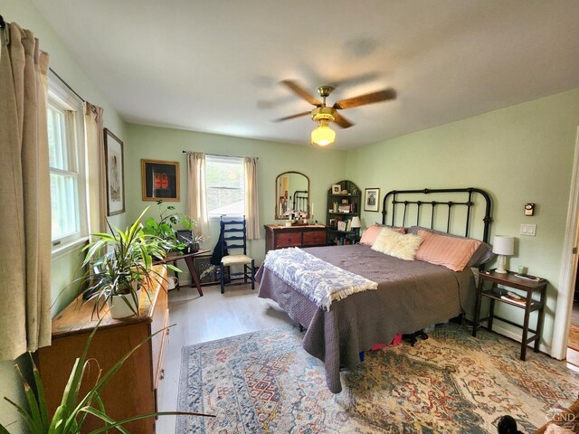 bedroom with wood finished floors and a ceiling fan