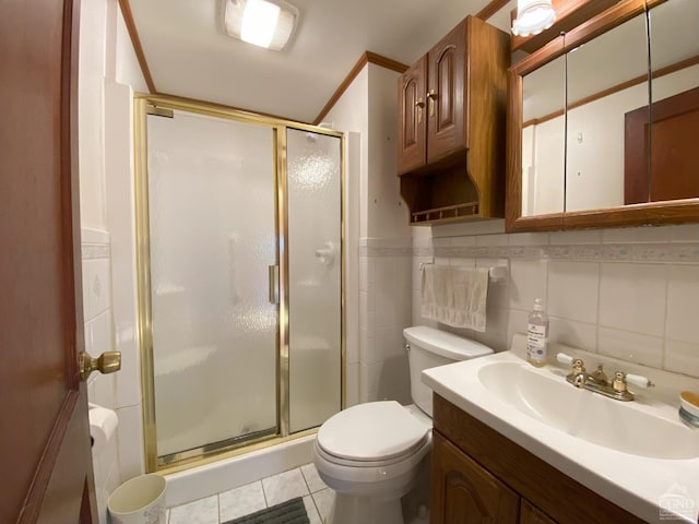 bathroom featuring tile patterned flooring, vanity, toilet, and walk in shower