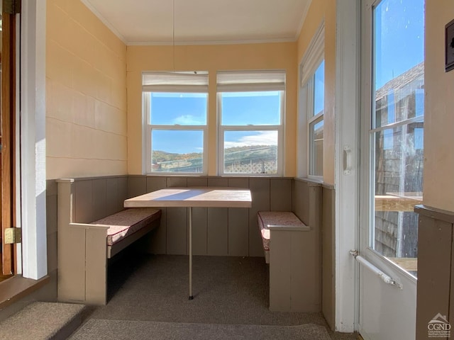 misc room with carpet flooring, breakfast area, and ornamental molding