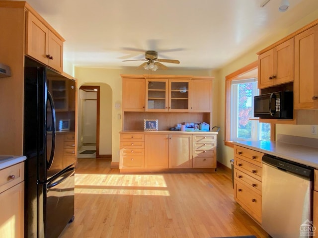 kitchen with light brown cabinetry, light hardwood / wood-style flooring, ceiling fan, and black appliances