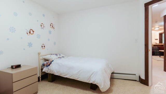 bedroom featuring a baseboard radiator and light colored carpet