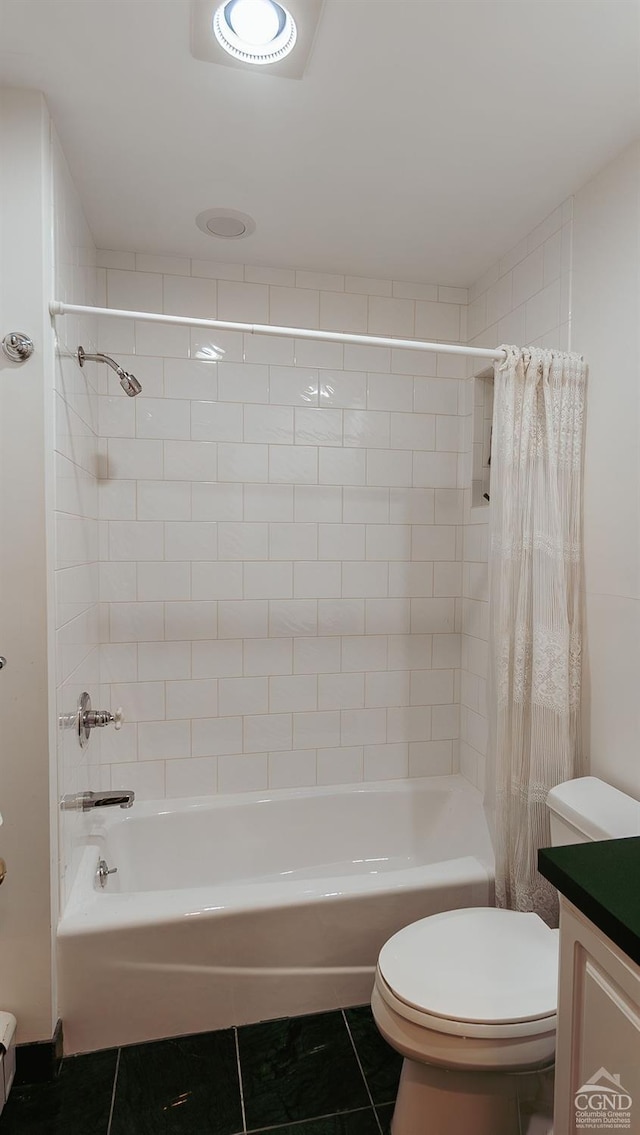 full bathroom with tile patterned floors, vanity, shower / tub combo, and toilet