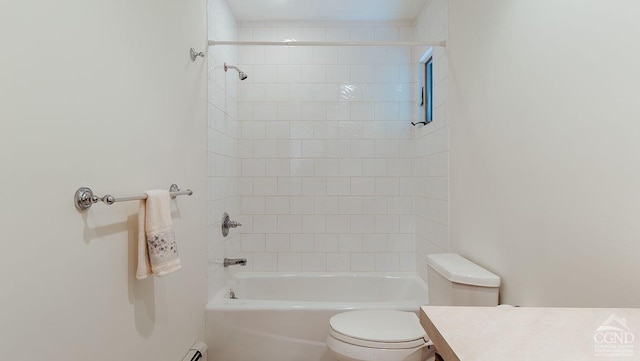 full bathroom with vanity, tiled shower / bath combo, and toilet