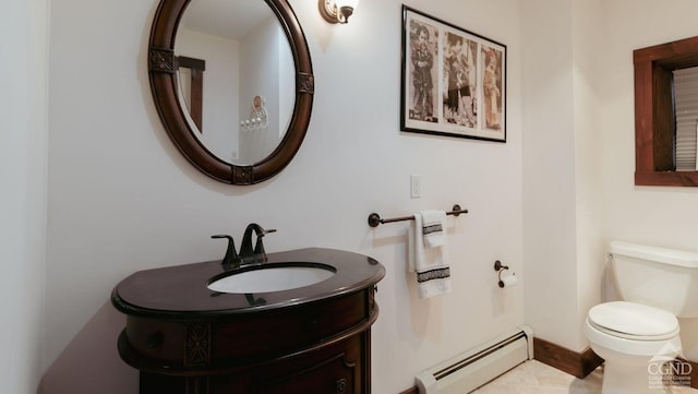 bathroom with vanity, toilet, and baseboard heating