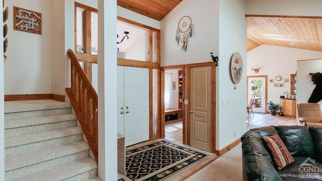 entrance foyer featuring high vaulted ceiling, a wealth of natural light, and wood ceiling