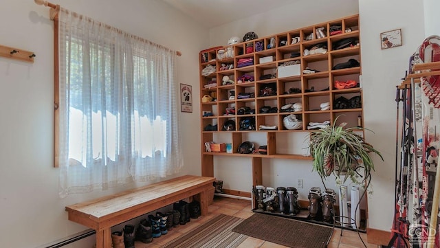 interior space featuring light tile patterned flooring and a baseboard heating unit