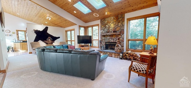 living room with wooden ceiling, light carpet, a stone fireplace, a skylight, and beam ceiling