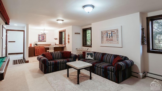 carpeted living room with an inviting chandelier