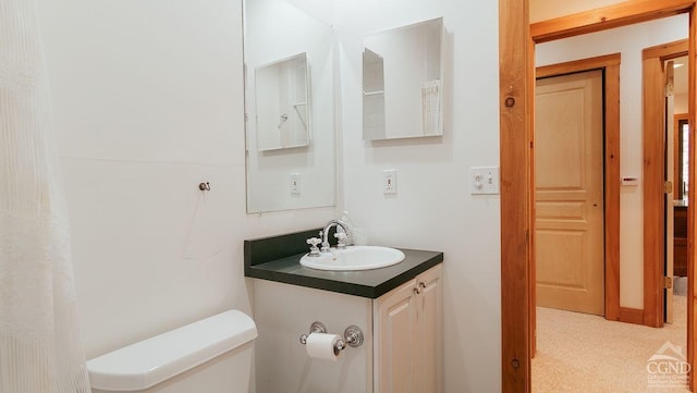 bathroom featuring vanity and toilet