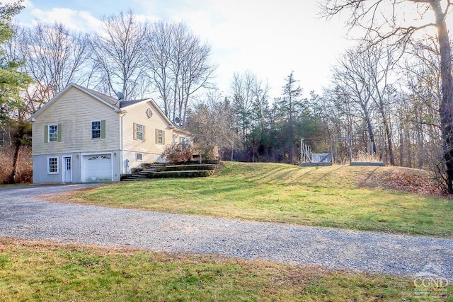 view of property exterior with a lawn and a garage