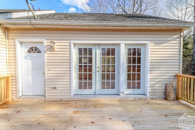 view of exterior entry with a deck and french doors